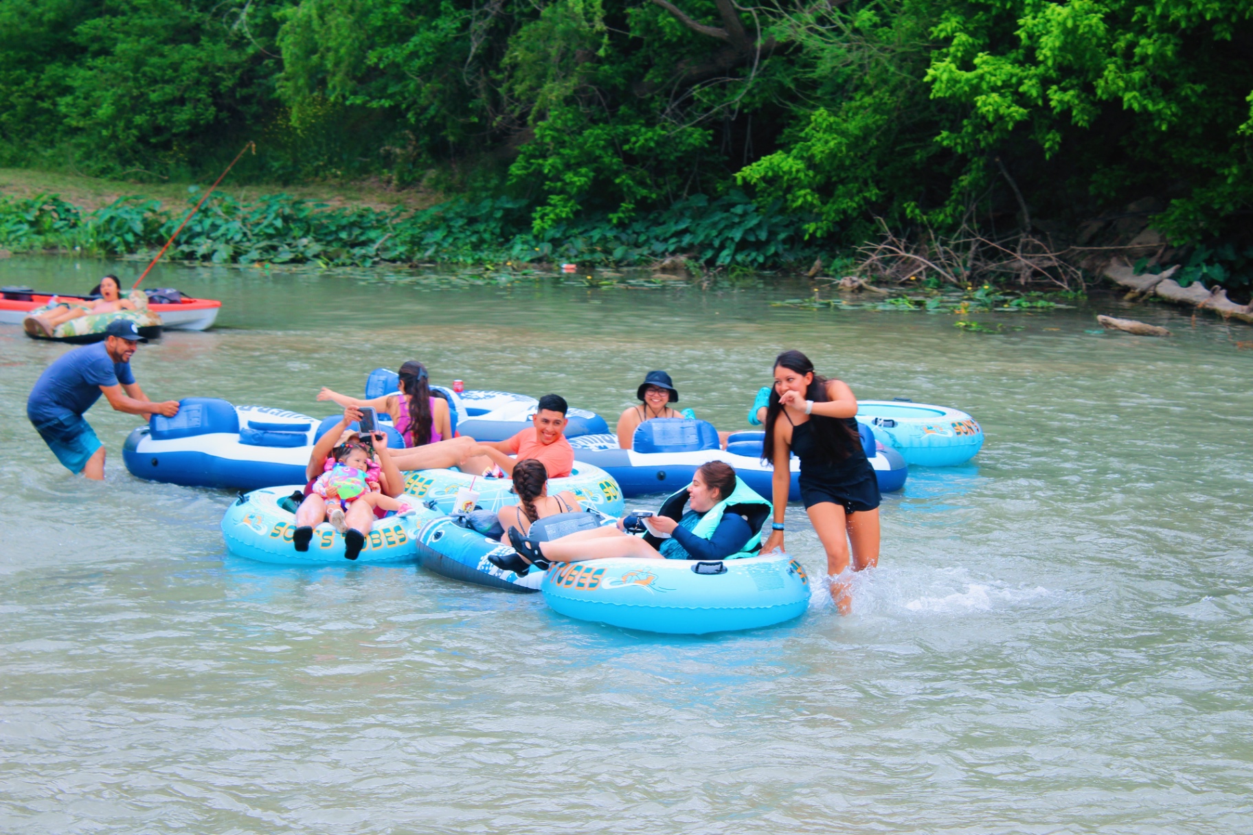 Family kayaking on the San Marcos River at Son's River Ranch