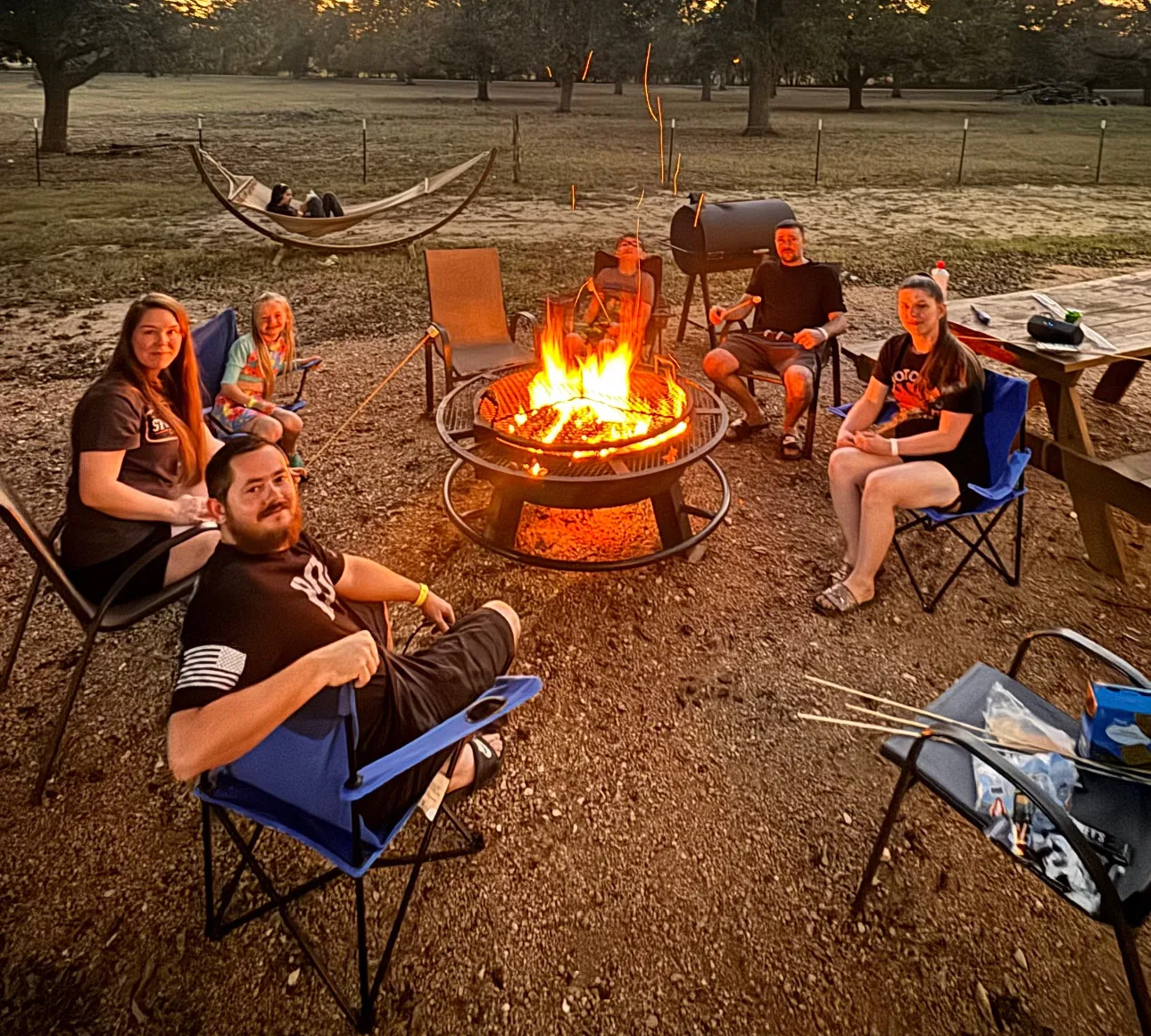 Family at firepit during glamping near San Antonio