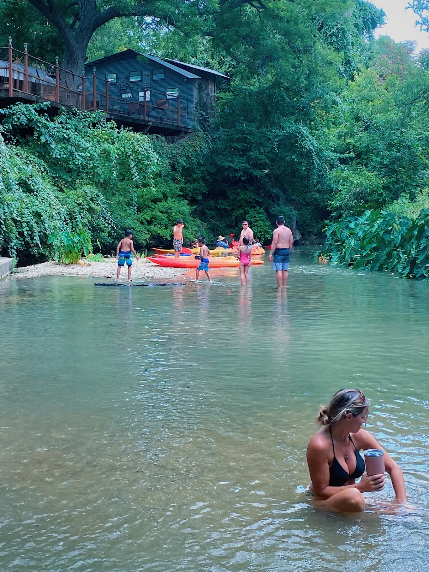 Kids swimming near tiki huts