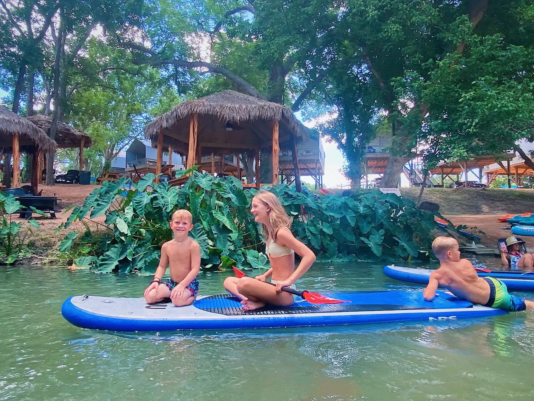 Kids on paddleboards in the creek