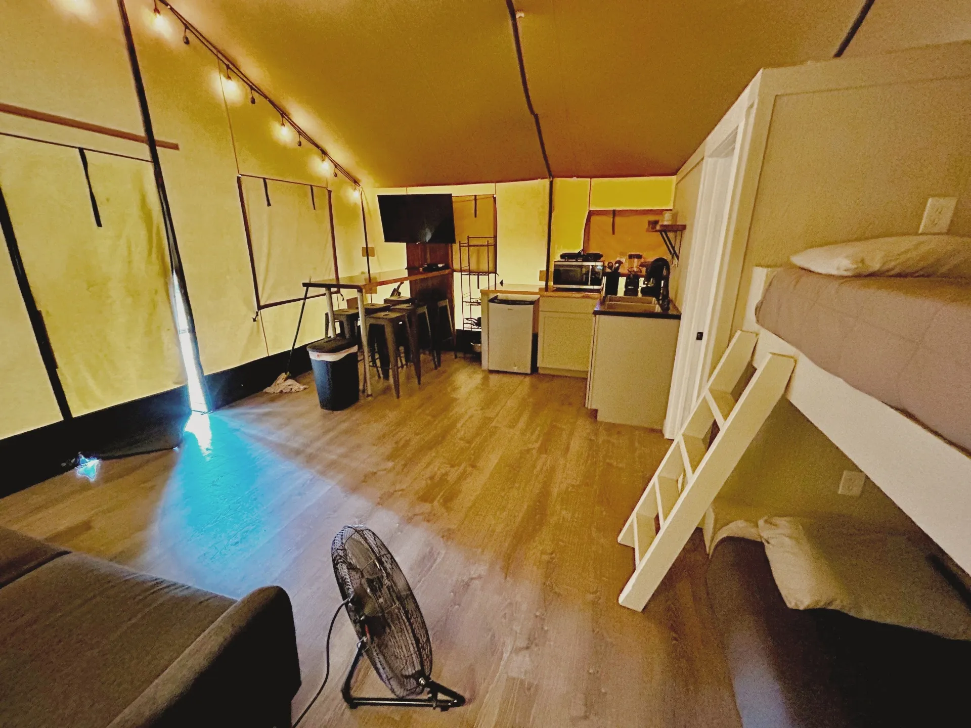 Safari Cabin living area with bunk beds and kitchen