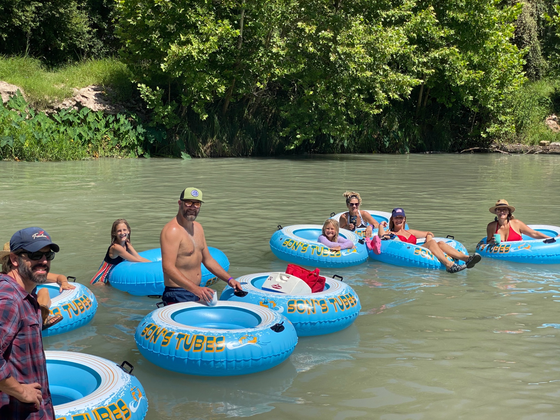 Friends enjoying family friendly tubing on the San Marcos River