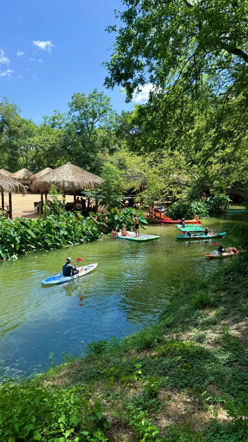 Kayakers and paddleboarders on creek