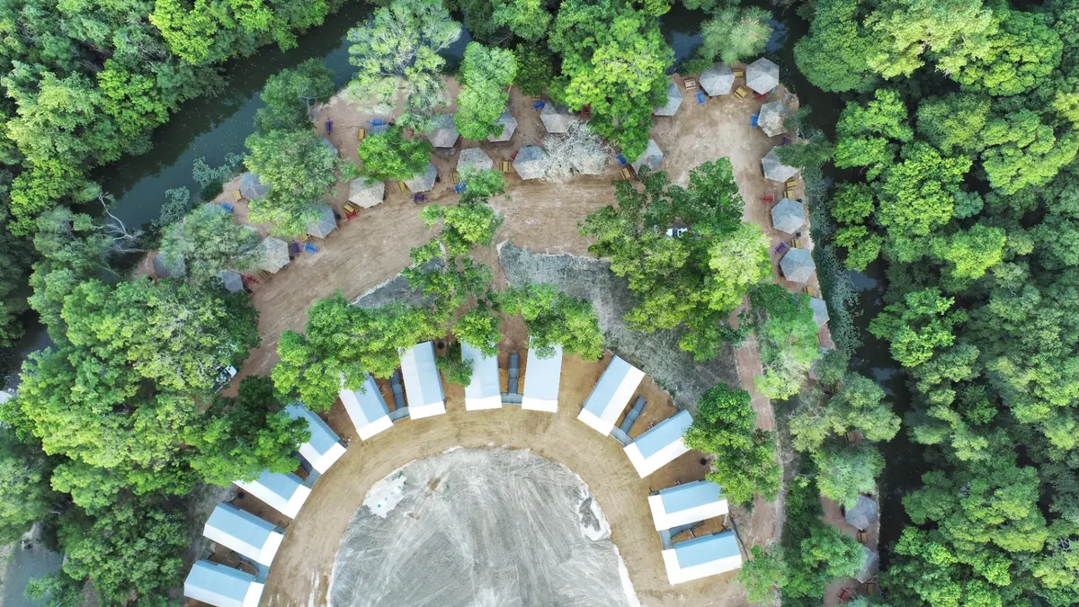 Aerial view of property with cabins and river